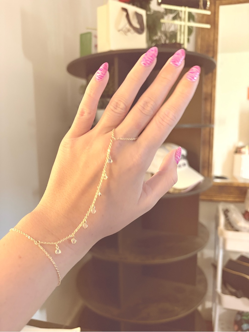 Altar'd State Gold Hand Chain with Dangle Charms and Pink Nails